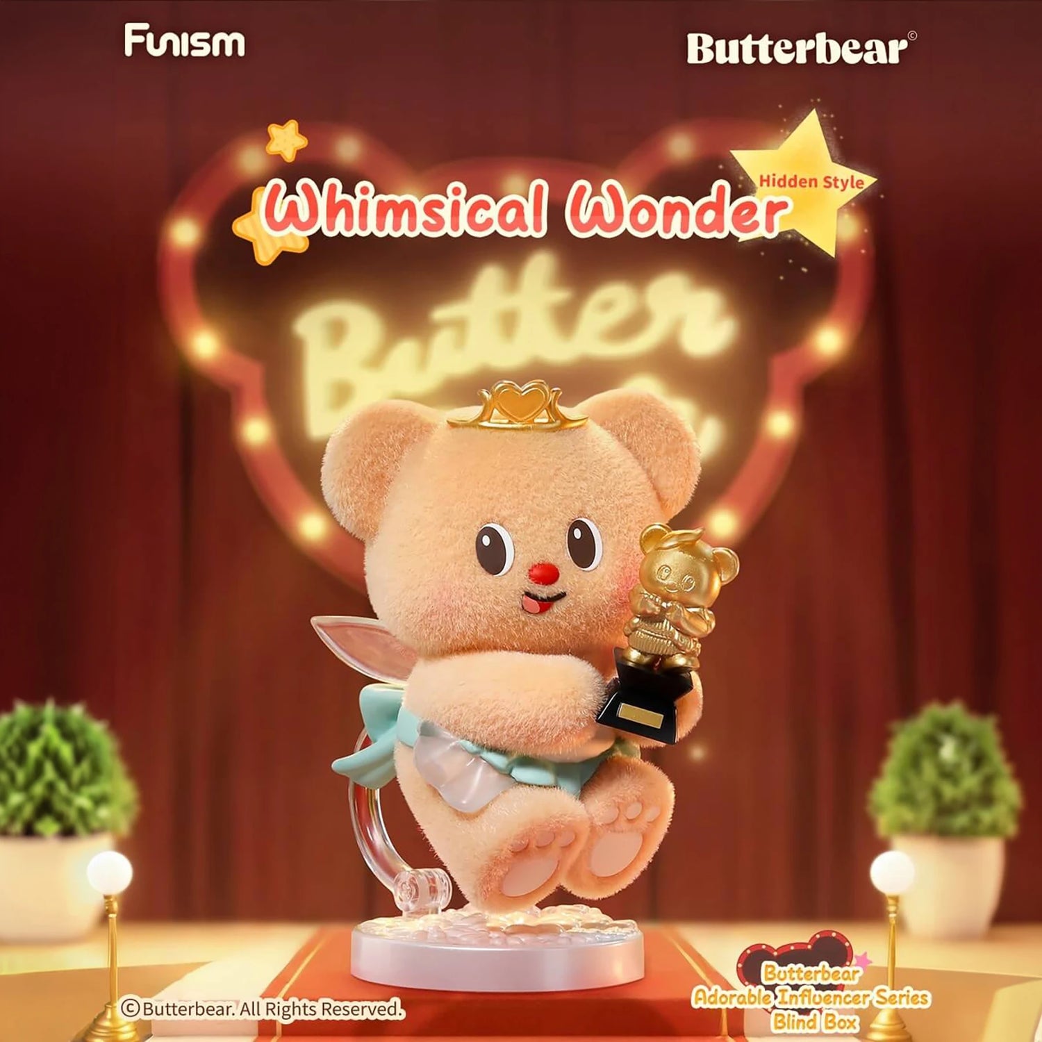 Fluffy bear figurine wearing crown and cape holding golden bear trophy on illuminated stage with red curtains background