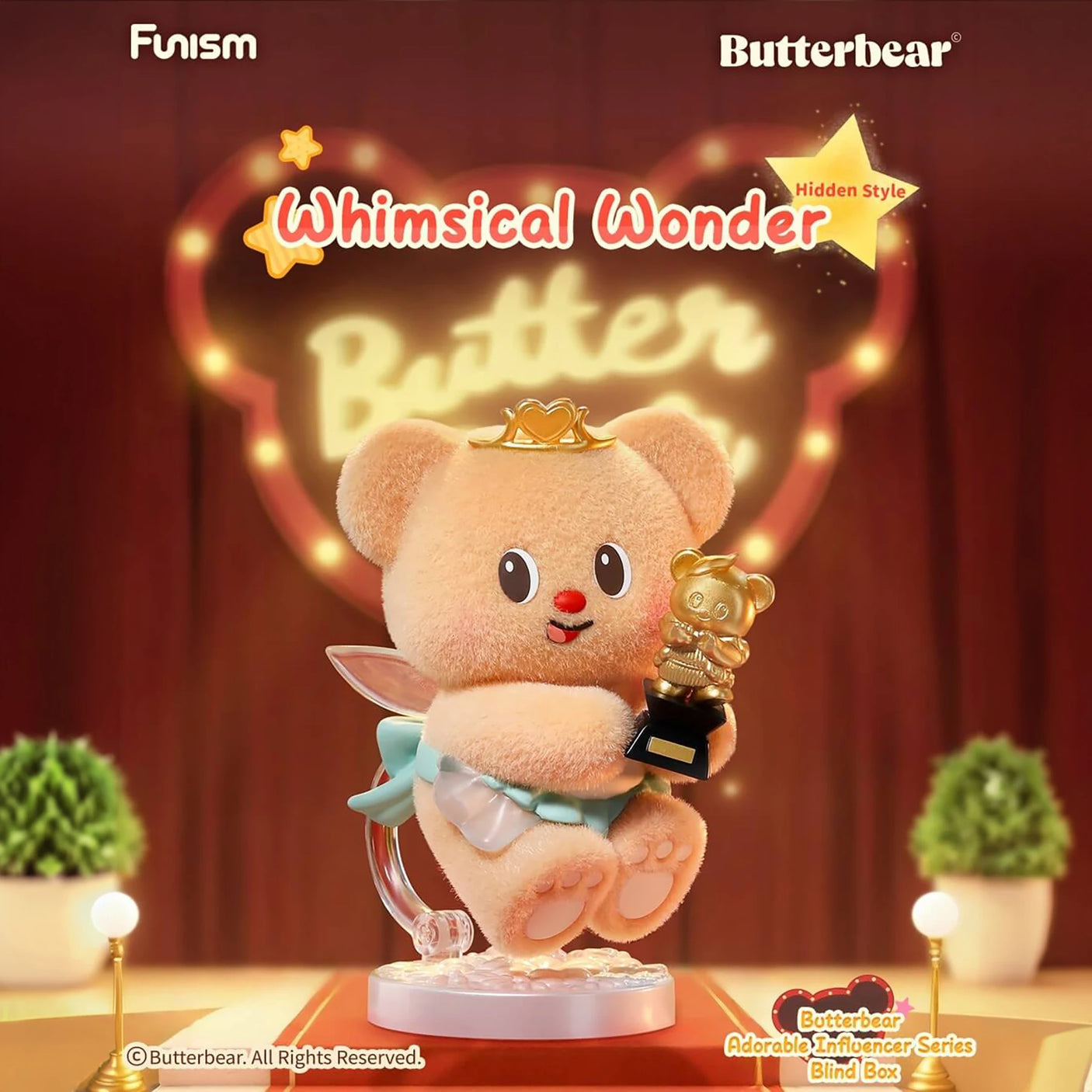 Fluffy bear figurine wearing crown and cape holding golden bear trophy on illuminated stage with red curtains background