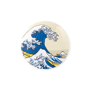 Round button badge with blue and white wave illustration and yellow accents