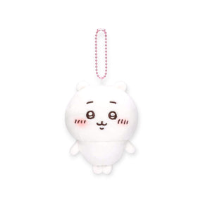 White Chiikawa plush keychain with embroidered facial details and pink blush on cheeks hanging by pink ball chain