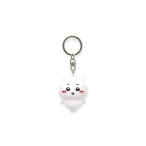 White plush keychain with smiling face, pink cheeks, and metal ring