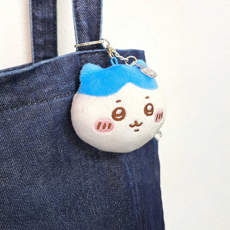 Chiikawa blue and white plush keychain with mirror charm attached, hanging from denim bag strap, promo image 1