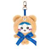Tan teddy bear plush keychain with blue ribbon and metal clip, cute smiling face.