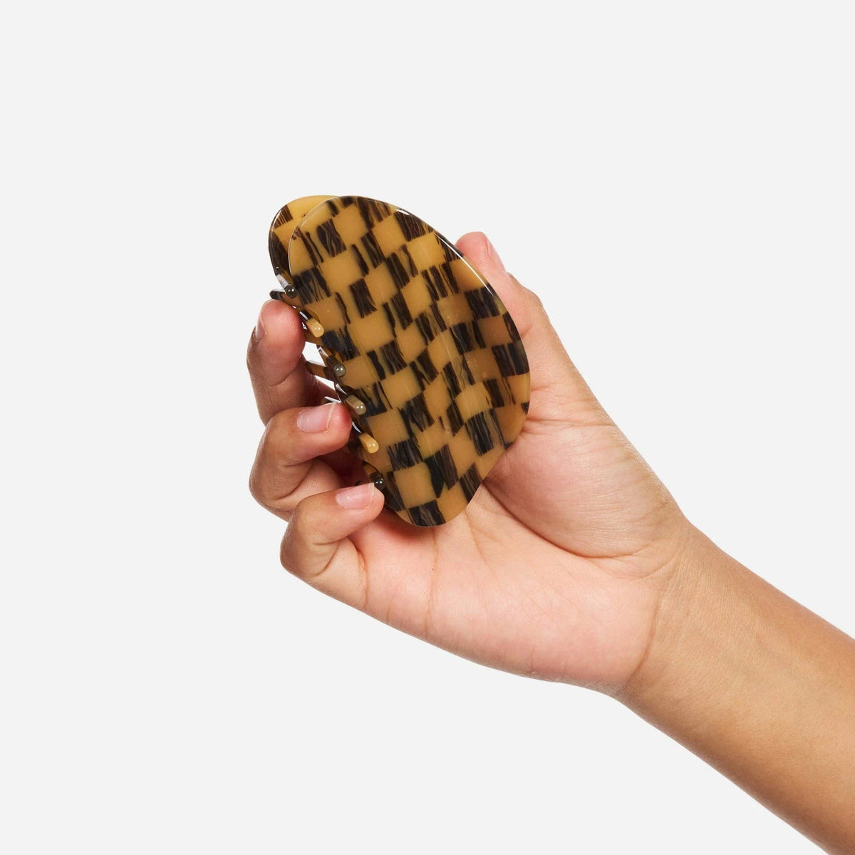 Mocha checker claw clip held in hand, long prongs