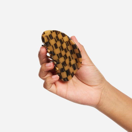 Mocha checker claw clip held in hand, long prongs