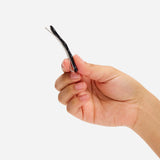 Black wavy hair slide clip held in hand
