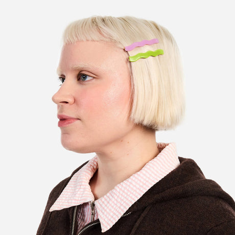Two wavy hair slide clips (lilac and lime) on blonde hair