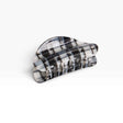 Chunky black-and-white plaid claw clip with ridged grip teeth
