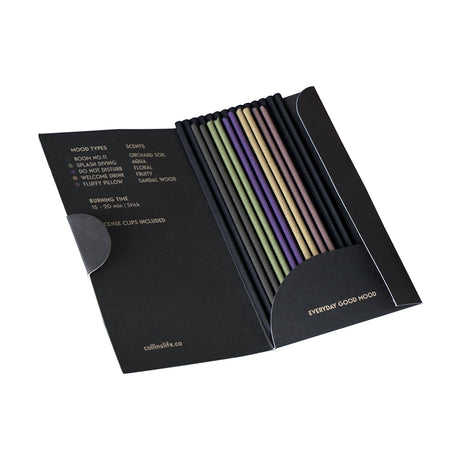 Opened black box of Collins Natural incense sticks showing five colors with scent and mood details inside flap