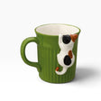 Green ceramic mug with calico cat face and tail decoration on side, white interior