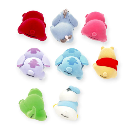 Set of eight small colorful plush characters viewed from the back, including blue, green, pink, purple, red, white, and yellow figures with details