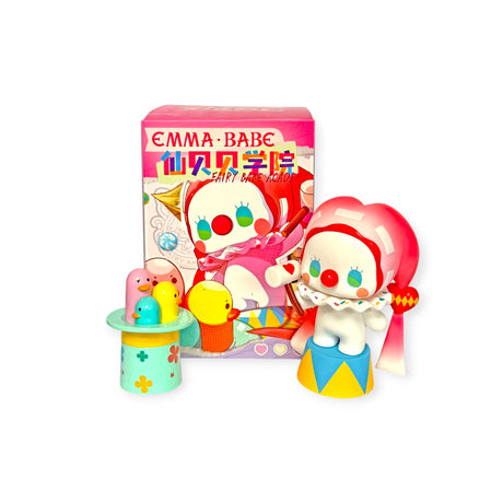 A toy clown with red cheeks and a pink scarf stands beside a colorful platform and matching box, from the Emma Fairy Babe Academy Blind Box collection by Lucky Emma.