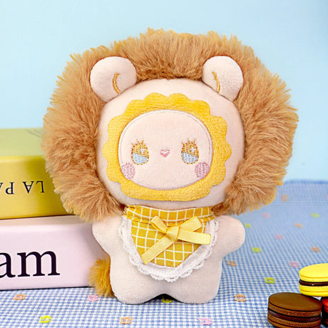 Fuzzy plush keychain shaped like a brown lion character with embroidered face and outfit.