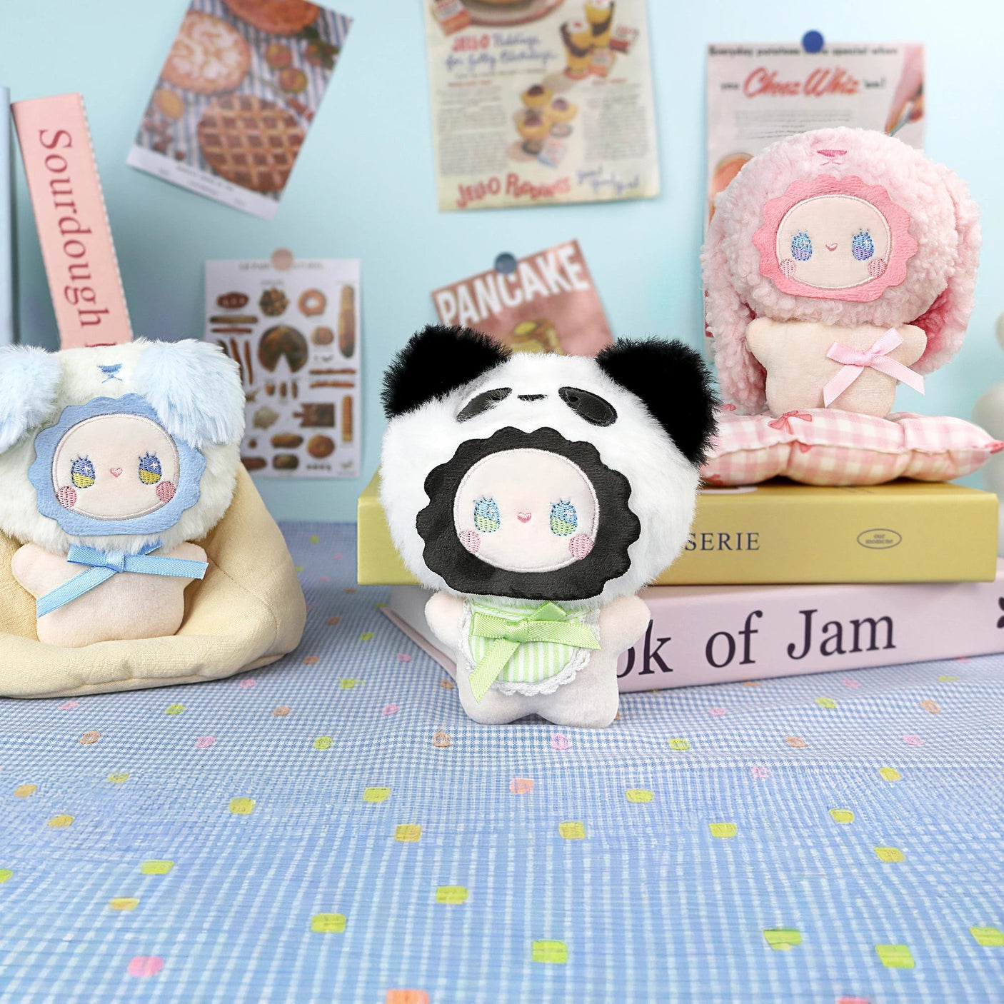 Fuzzy plush keychain with panda face and green shirt, sitting pose, gold key ring
