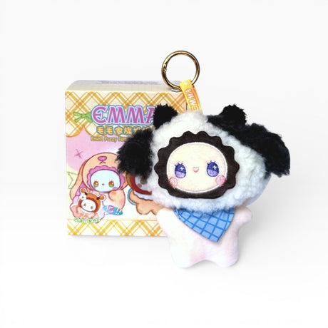 Fuzzy plush keychain featuring black-and-white panda character with gold ring and tag.