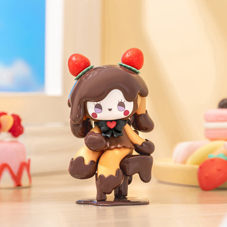 Chocolate-themed Emma Secret Forest Love Dopamine figure with strawberry ears and heart detail on wooden table by window