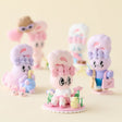 Pastel bunny blind box figure in blue overalls holding green flowers