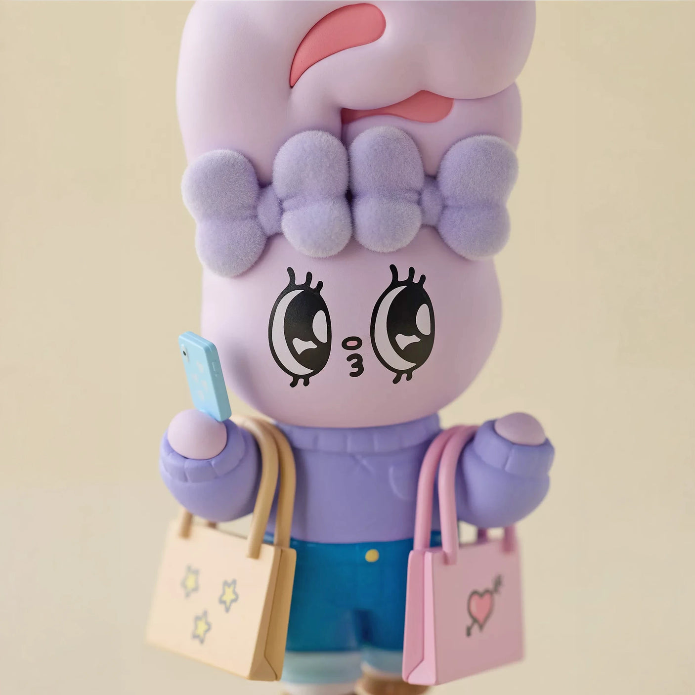 Lavender bunny blind box figure with large eyes, holding small shopping bags