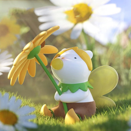 Whimsical Finding Unicorn REPOLAR Magical Garden figure with yellow wings holding large yellow flower outdoors in soft sunlight