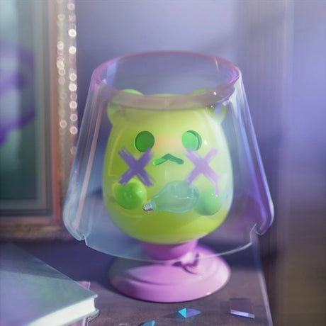 Neon green ShinWoo Ghost Bear figure with pink X eyes under translucent purple dome on round base in moody lighting