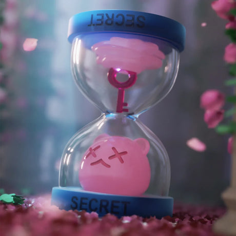 Pink ShinWoo Secret Bear figure inside clear hourglass with blue rim and key inside on blurred floral background