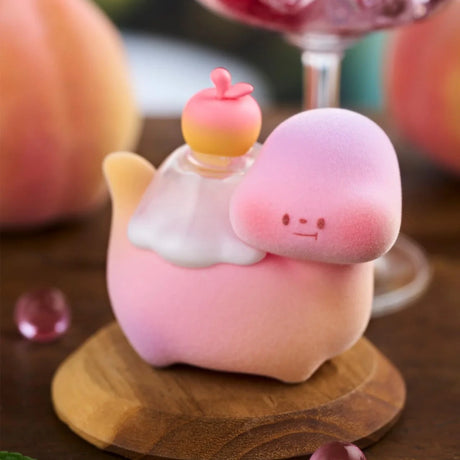 Close-up of pastel pink and yellow Food Dinosaur Fuji Yama Vol. 2 figure with peach detail on wooden display stand