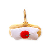 Rolled yellow plush zip pouch with white top and red cherry accent, gold keyring