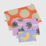 Explore the Baggu Go Pouch Set - Japanese Produce by Baggu, made from recycled materials and featuring vibrant fruit and leaf designs. It includes three pouches perfect for essentials: large orange, medium purple, and small blue.