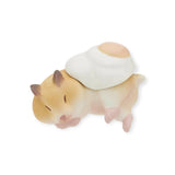 This charming surprise figure showcases a small sleeping hamster figurine with a fried egg on its back, from the whimsical Hamster ‘N Egg Blind Box collection by Kitan Club, set against a plain white background.