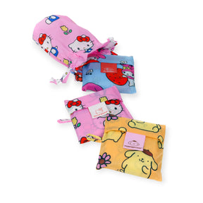 Three colorful, reusable Baggu x Hello Kitty bags featuring Sanrio characters are displayed on a white background.