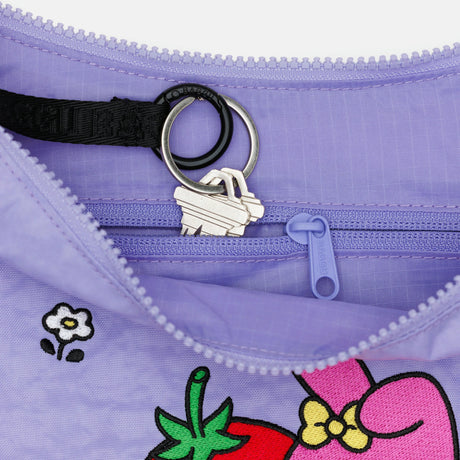Close-up of lavender Hello Kitty x Baggu Medium Nylon Crescent My Melody bag showing interior zipper and key rings, detail view