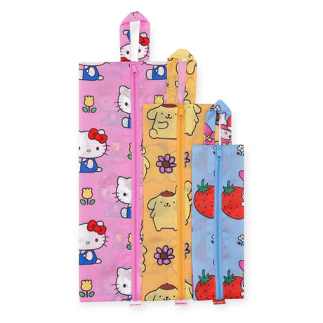 The Hello Kitty x Baggu Storage & Travel Set by Baggu includes three limited-edition zipper pouches in pink, yellow, and blue, each with a unique pattern—Hello Kitty, dogs with flowers, and strawberries with bunnies.
