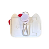 The Hello Kitty Card Pass Case is a white cardholder made from durable silicone with a carabiner clip and retractable badge reel attached.