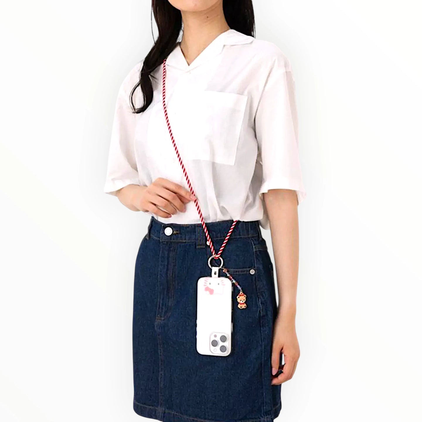Hello Kitty phone strap worn crossbody; striped cord with teddy bear charm