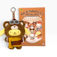 Bear plush keychain with glasses, yellow outfit, and round key ring attached.