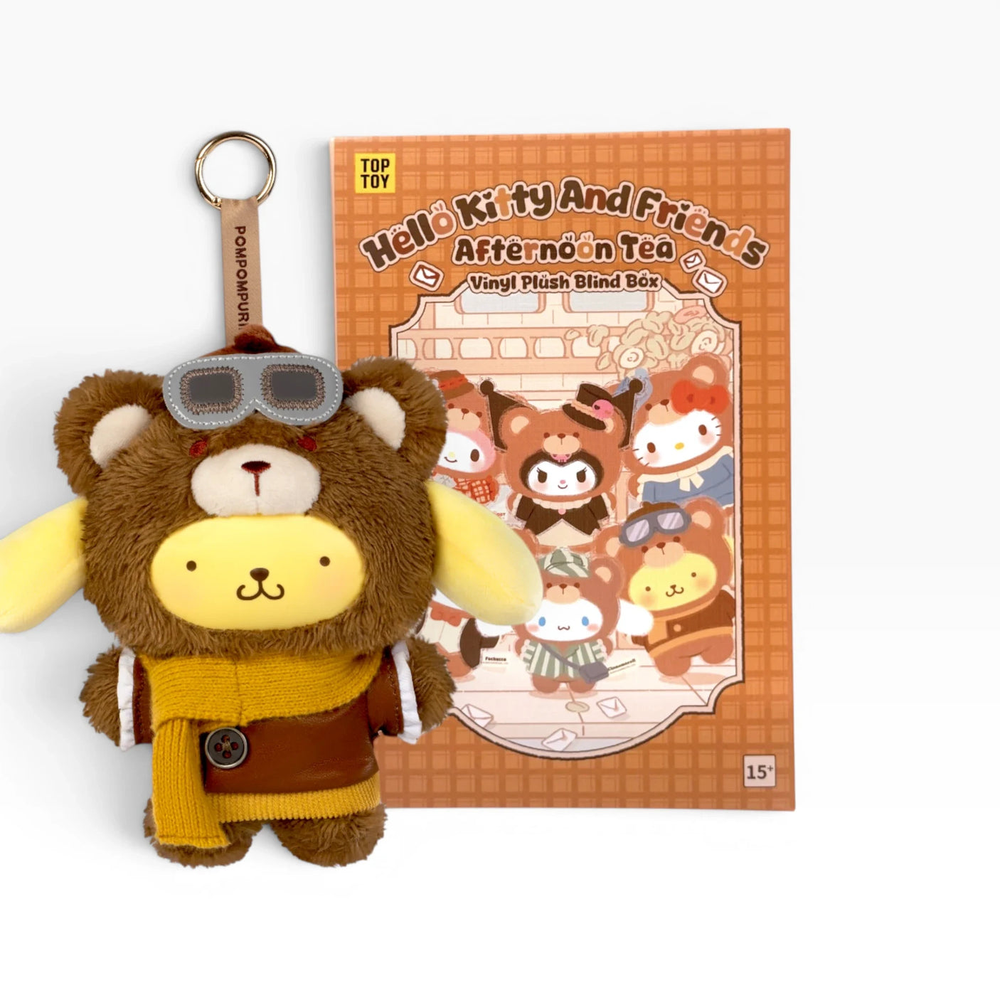 Bear plush keychain with glasses, yellow outfit, and round key ring attached.
