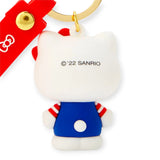 The Hello Kitty 3D Figure - Keychain features Hello Kitty's iconic back view in a blue outfit with a red bow, complemented by a red strap and gold ring for a unique touch.