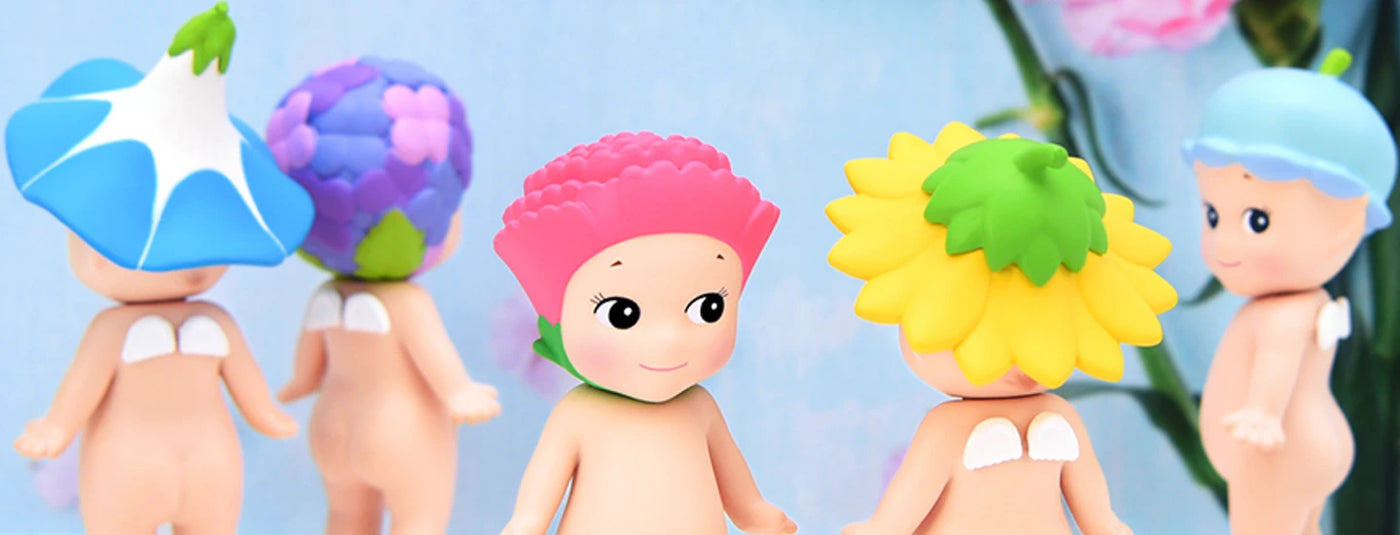 Toy figures with flower hats stand on a blue background.