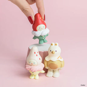 Red mushroom-style animal figurine held in hand with two matching figures