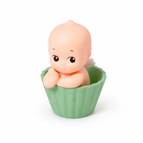 Kewpie baby figure in green ribbed cup, hands on chin