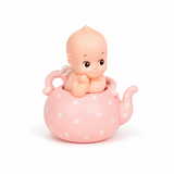 Kewpie baby figure in pink polka-dot teapot with white dots