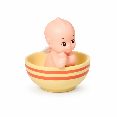 Kewpie baby figure in striped cup, yellow bowl with orange and red stripes