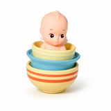 Kewpie baby figure in striped cup, pastel blue and yellow bowls