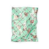 Mint fabric square with cartoon baby figures and pink floral vine lattice pattern