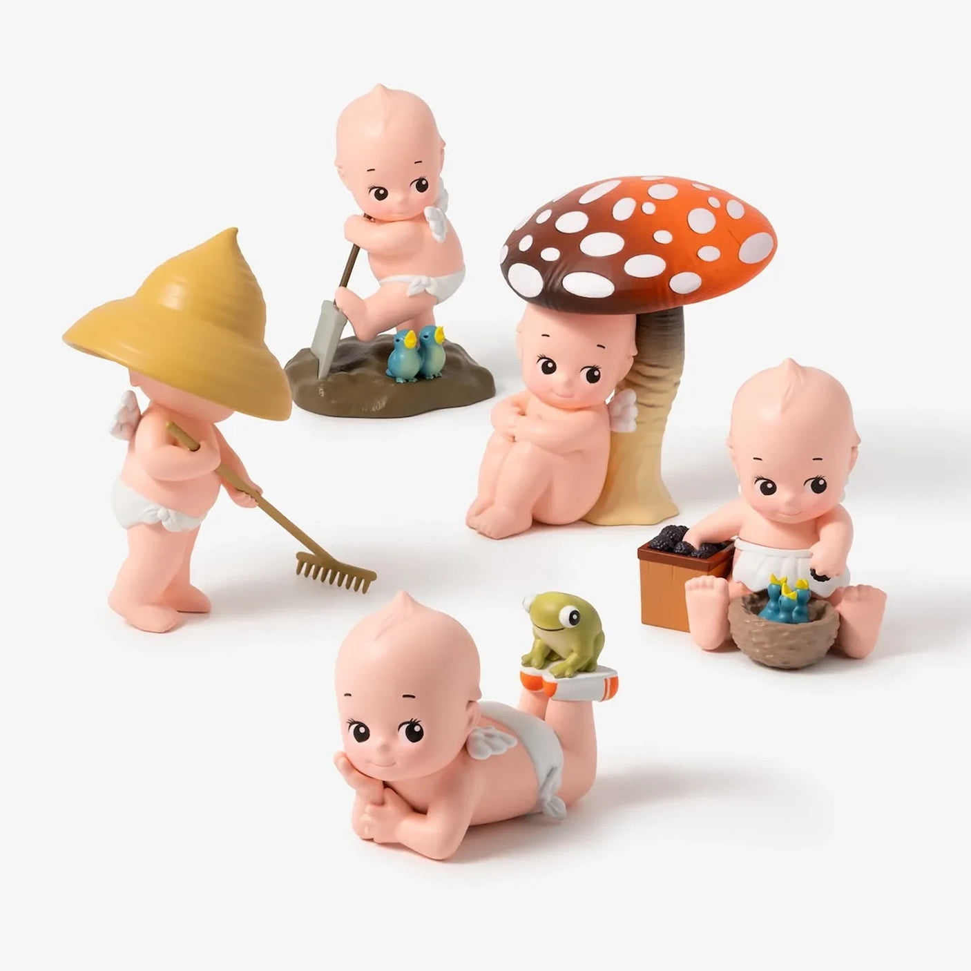 Kewpie In the Garden figurine set with mushroom hats and small gardening tools