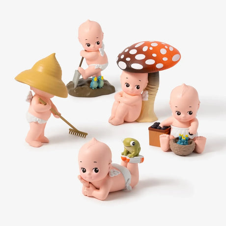 Kewpie In the Garden figurine set with mushroom hats and small gardening tools