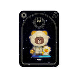 The Kwistal toy figure from the Mighty Jaxx - Kwistal Line Horoscope Primus Blind Box is dressed as a sheep with bear features, accompanied by a yellow duck on a starry "Aries" background. Discover this charming blind box collectible that brings your zodiac sign to life.