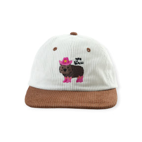 Brown and white corduroy cap with embroidered wombat wearing pink cowboy boots and hat with text "yee haw