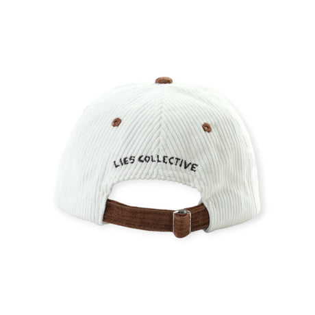 Back view of white corduroy cap with brown adjustable strap and black embroidered Lies Collective text above opening
