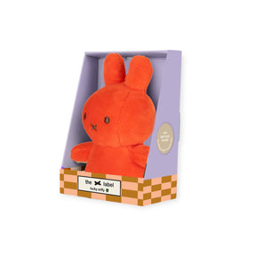 Coral Mini Miffy plush seated in open lavender and checkerboard gift box with sustainable filling badge visible